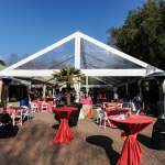 A large tent is set-up in the zoo filled with well-dressed tables.