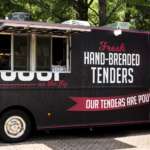 A food truck selling chicken tenders with a large chicken depicted on its side.