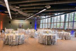 An event space set up with tables, linens and chairs