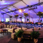 An event space set up with tables, linens and chairs