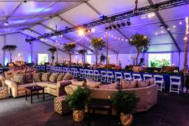 An event space set up with tables, linens and chairs