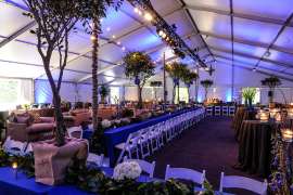 An event space set up with tables, linens and chairs