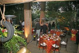 An event space set up with tables, linens and chairs
