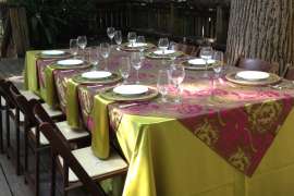 An event space set up with tables, linens and chairs