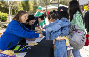 An Education Volunteer interacts with guests during BioMechanics Day.