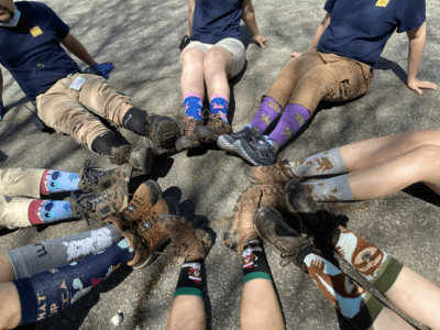 zoo staff members sit in a circle showing off silly socks