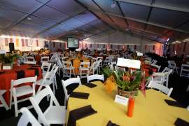 An event space set up with tables, linens and chairs