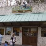 The extrerior of the Willie B's restaurant in the Zoo as a family walks by.